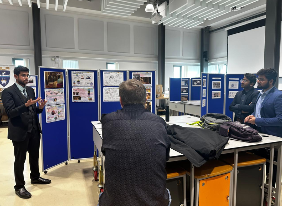 Manish presenting the Vivid project at a poster board during the design crit